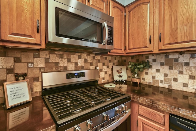 kitchen featuring brown cabinets, dark countertops, tasteful backsplash, and stainless steel appliances