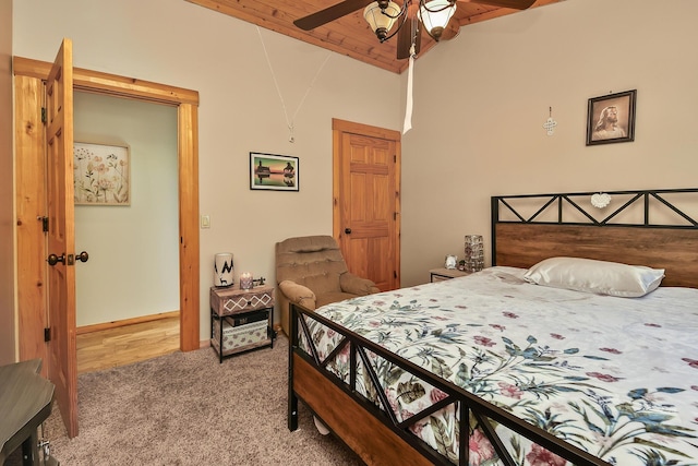 bedroom featuring lofted ceiling, light carpet, and baseboards