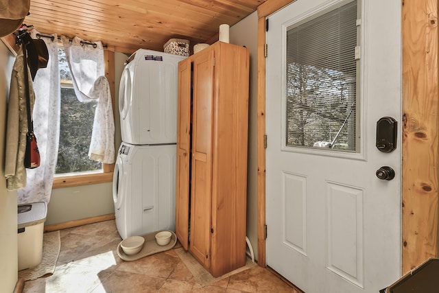 laundry area featuring stacked washer and dryer, wood ceiling, and laundry area