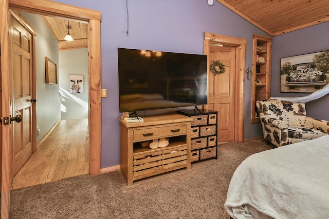 bedroom featuring lofted ceiling, wooden ceiling, baseboards, and carpet floors