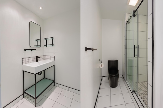 full bathroom with toilet, a stall shower, a sink, and tile patterned floors