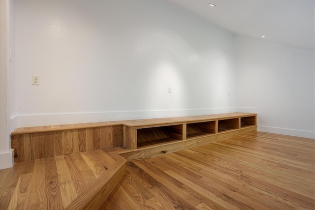 mudroom featuring lofted ceiling and wood finished floors