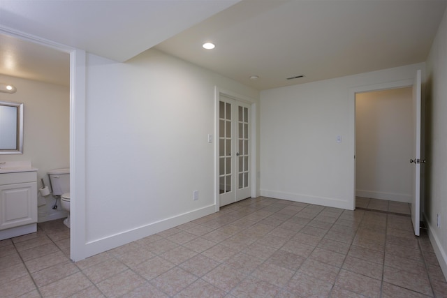 empty room featuring recessed lighting, visible vents, baseboards, and french doors