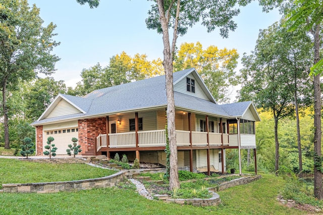 view of front of property featuring an attached garage, brick siding, a front yard, and roof with shingles