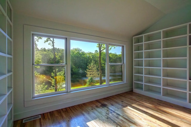 unfurnished sunroom with visible vents and vaulted ceiling