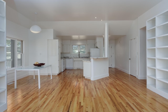 kitchen featuring lofted ceiling, white appliances, light wood-style flooring, and white cabinets