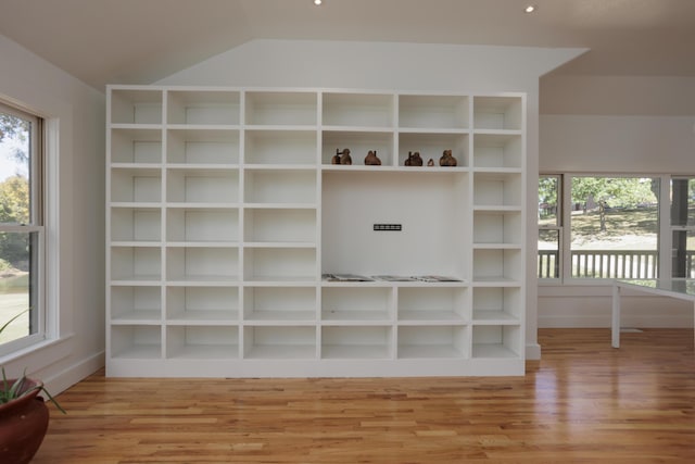 unfurnished living room with vaulted ceiling and wood finished floors