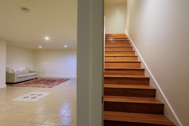 staircase with tile patterned flooring, baseboards, and recessed lighting