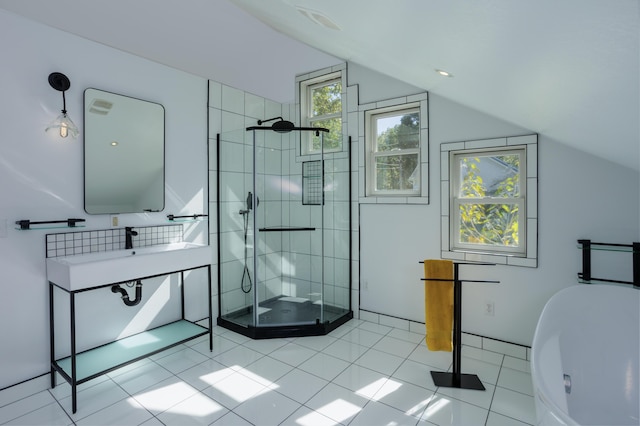 bathroom with lofted ceiling, a stall shower, and tile patterned flooring