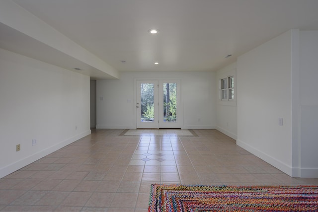 unfurnished room featuring recessed lighting, baseboards, and light tile patterned flooring