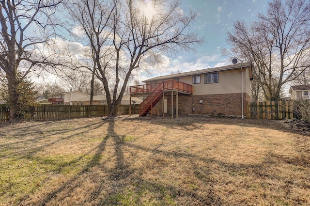 view of yard with a fenced backyard, a deck, and stairs