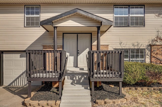 view of exterior entry with an attached garage