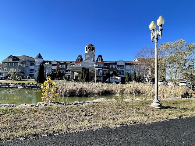 view of building exterior with a residential view and a water view