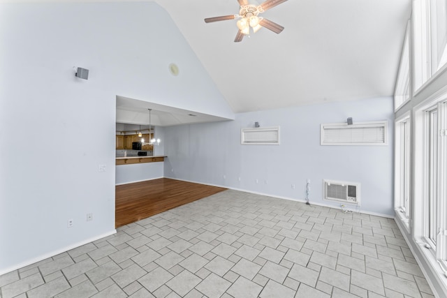 unfurnished living room featuring a ceiling fan, visible vents, high vaulted ceiling, and baseboards