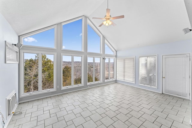 unfurnished sunroom featuring a wealth of natural light, vaulted ceiling, visible vents, and ceiling fan