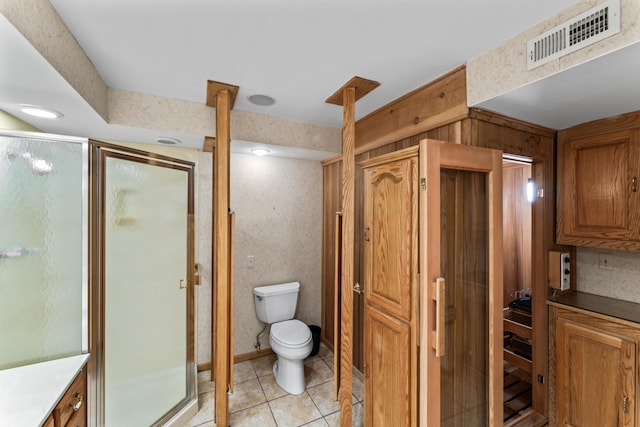 full bathroom featuring tile patterned flooring, visible vents, a shower stall, and toilet