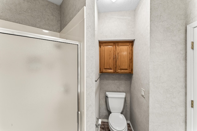 full bathroom with a shower stall and toilet