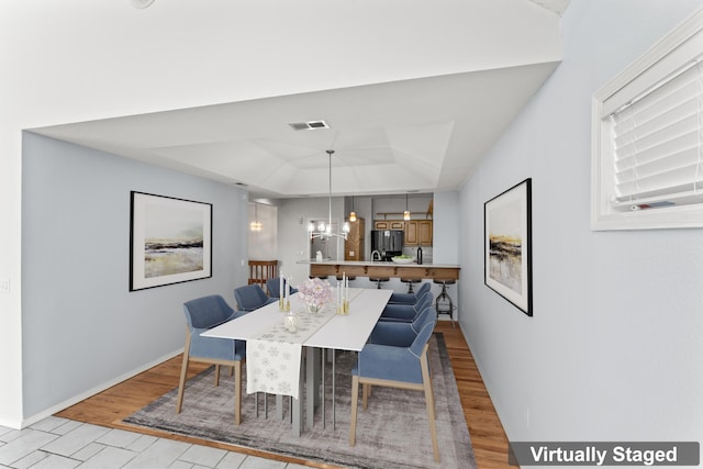 1701 Cedar Ridge Way, Branson West, MO 65737 - dining space featuring a tray ceiling, a chandelier, light wood-type flooring, and baseboards