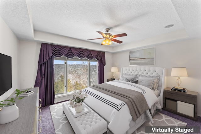 1701 Cedar Ridge Way, Branson West, MO 65737 - bedroom featuring carpet, a tray ceiling, a textured ceiling, and a ceiling fan