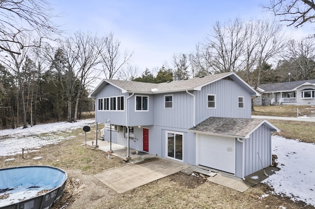 rear view of property featuring roof with shingles and a patio area