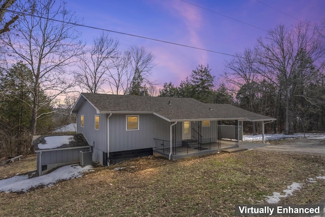 view of front of home featuring roof with shingles and central AC unit