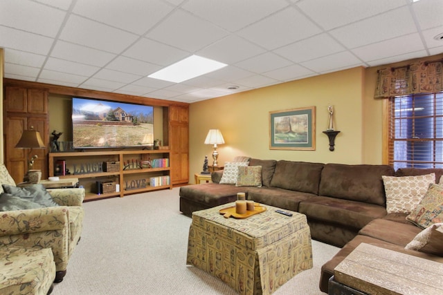 living room featuring a paneled ceiling and carpet flooring