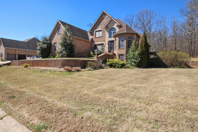 view of front of house with brick siding and a front yard