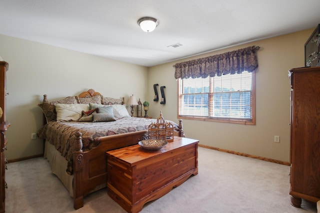 bedroom featuring light colored carpet, visible vents, and baseboards