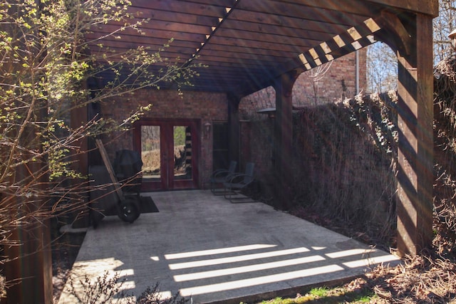 view of patio / terrace with french doors, fence, and a pergola