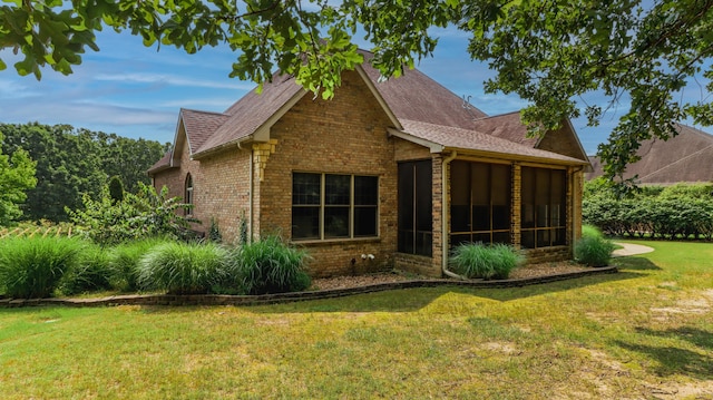 1165 Susan Dr, West Plains, MO 65775 - view of property exterior with brick siding, a sunroom, a lawn, and a shingled roof