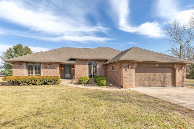 view of front of home with an attached garage, concrete driveway, and brick siding