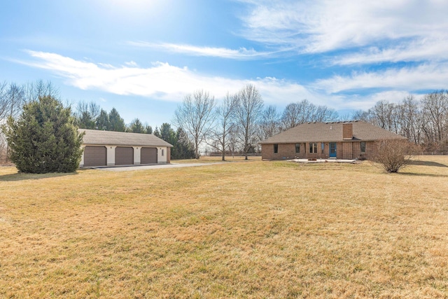 view of yard with a garage and an outdoor structure