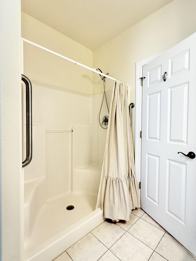 full bathroom with a shower stall and tile patterned floors