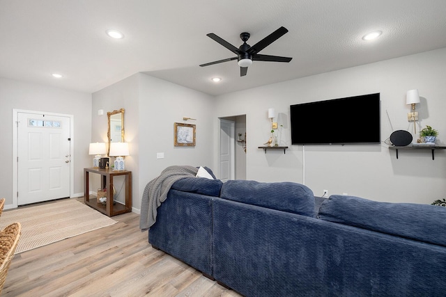 living area featuring a ceiling fan, recessed lighting, light wood-style flooring, and baseboards