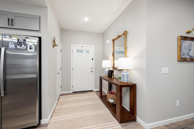 interior space featuring light wood-type flooring and baseboards