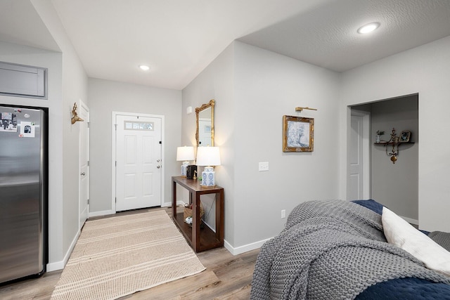 entrance foyer with light wood finished floors, recessed lighting, and baseboards