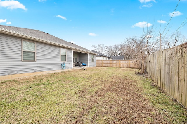 view of yard with a fenced backyard