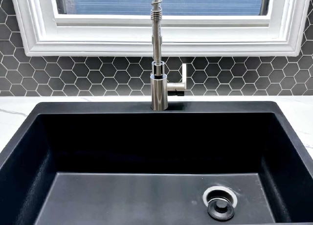 details with white cabinetry and a sink