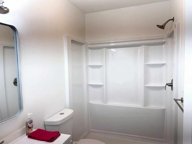 full bath featuring toilet, a stall shower, and vanity