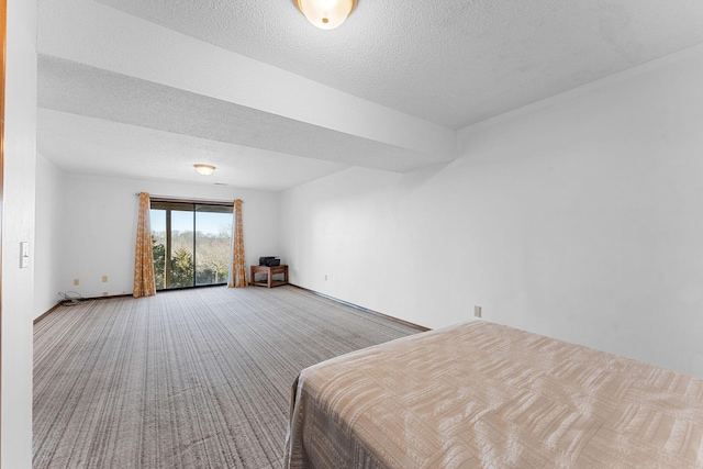 unfurnished bedroom featuring carpet floors and a textured ceiling