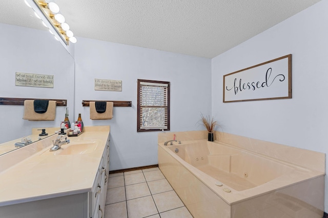 full bath with a textured ceiling, tile patterned flooring, vanity, baseboards, and a jetted tub