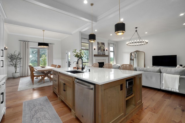 kitchen with a fireplace, appliances with stainless steel finishes, a sink, light wood-type flooring, and beamed ceiling