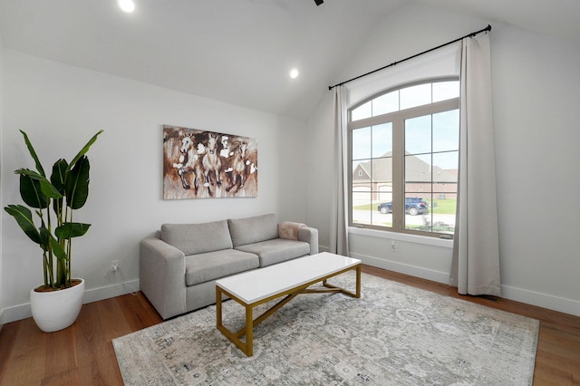 living area with lofted ceiling, baseboards, wood finished floors, and recessed lighting