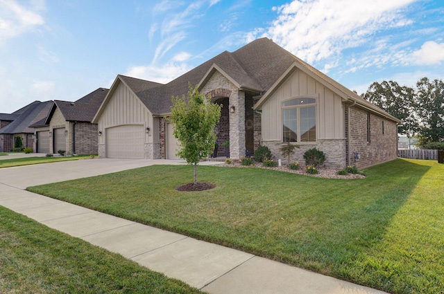 view of front of house with a garage, driveway, stone siding, a front lawn, and board and batten siding