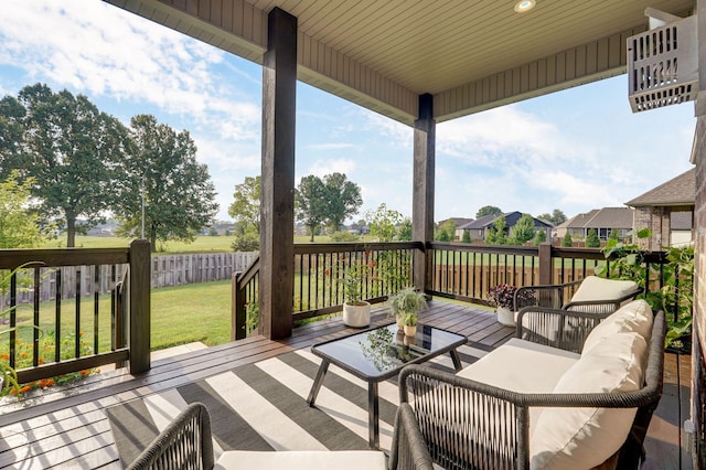 wooden terrace with fence, an outdoor hangout area, and a yard