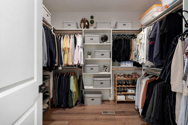 walk in closet featuring wood finished floors and visible vents