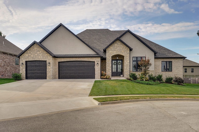 french country home featuring roof with shingles, stucco siding, concrete driveway, a garage, and a front lawn