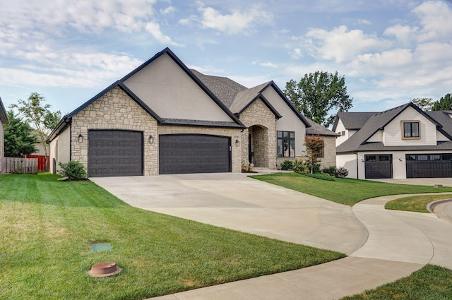 french country inspired facade with a garage, a front yard, and driveway