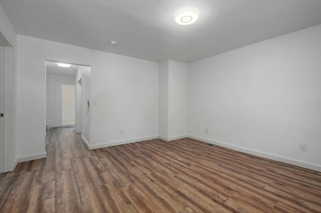 unfurnished room with wood finished floors and baseboards