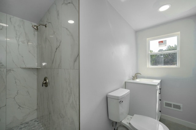 full bath with toilet, vanity, visible vents, baseboards, and a marble finish shower